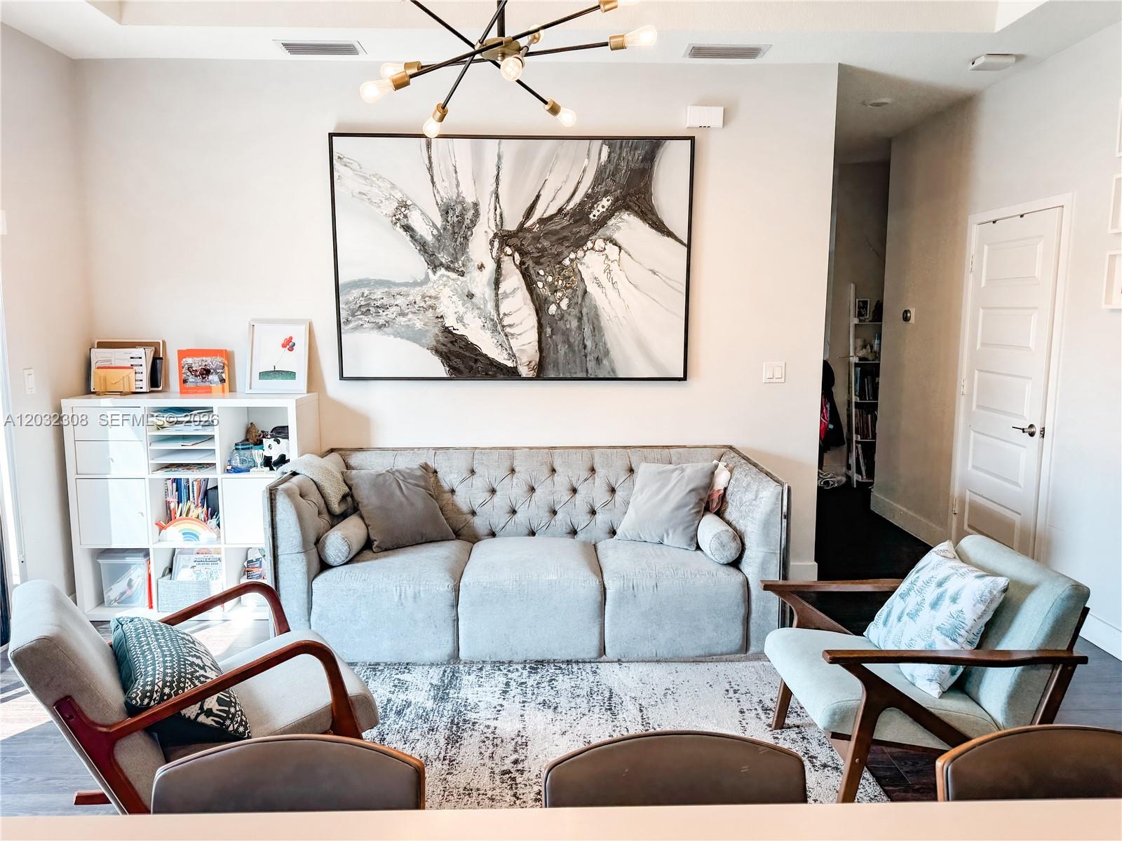 A living room features a tufted gray sofa, two armchairs, and a large abstract painting — 10455 NW 82nd St # 32, Doral FL 33178, DORAL, FL