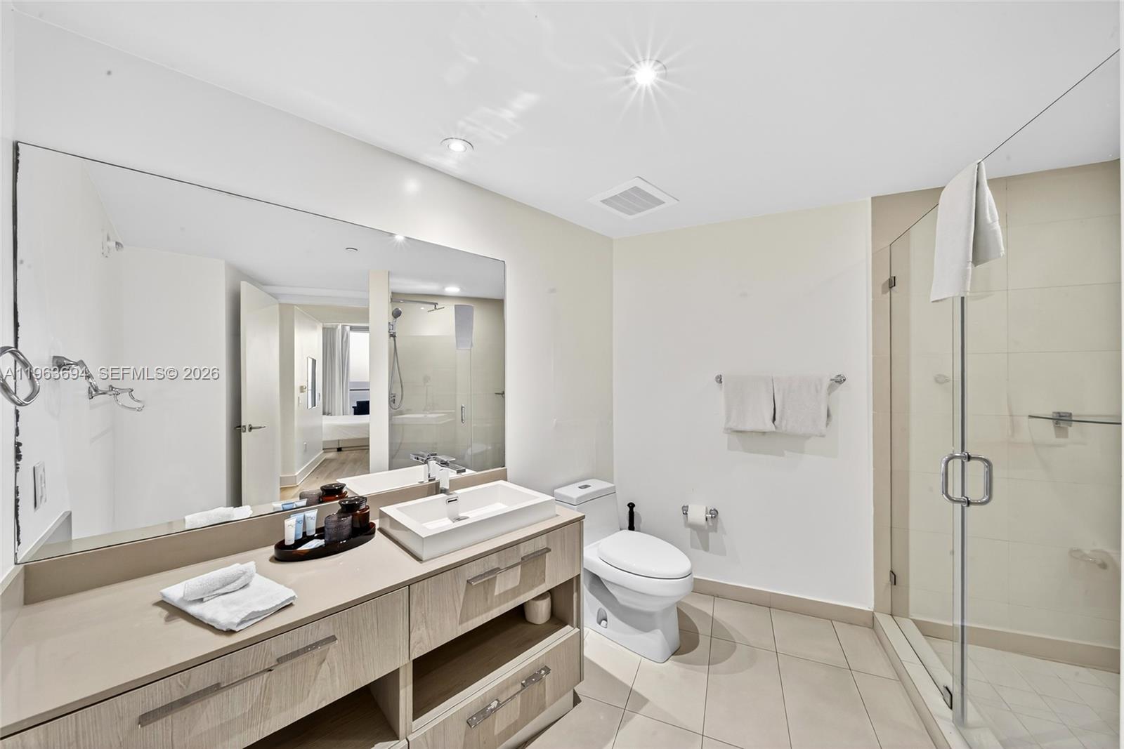 A modern bathroom features a light wood vanity, a vessel sink, and a glass shower — 4111 S Ocean Dr # 3703, Hollywood FL 33019, HOLLYWOOD, FL
