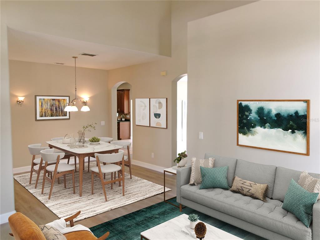 This open-concept living and dining area features high ceilings, neutral walls, and modern furniture — 11314 OYSTER BAY CIRCLE, NEW PORT RICHEY, FL
