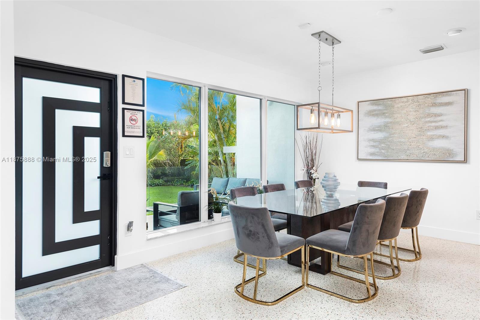 A dining room features a glass table, grey velvet chairs, and large floor-to-ceiling windows — 1019 NE 87th St, Miami FL 33138, MIAMI, FL