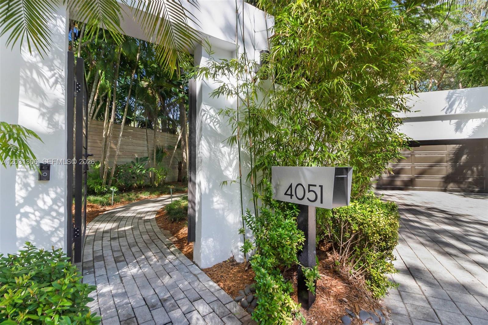 A modern white gate and a metal mailbox labeled 4051 stand beside a paved walkway — 4051 Ensenada Avenue, Miami FL 33133, MIAMI, FL