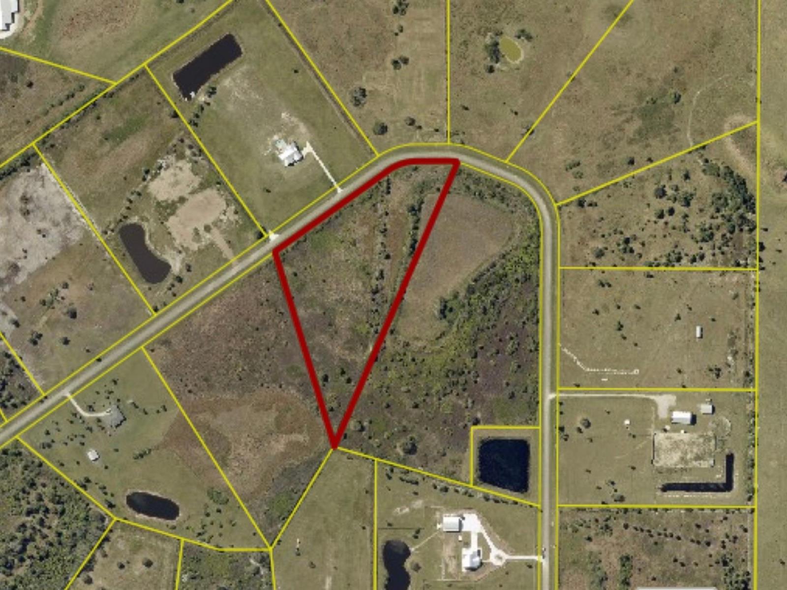 An aerial view shows a triangular vacant lot outlined in red within a rural subdivision — 6617 SE 26th Trail, Okeechobee FL 34974, OKEECHOBEE, FL