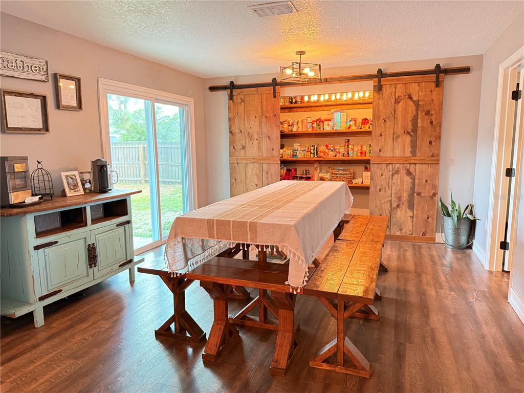 A staircase with dark wood treads and white risers leads to a landing — 10056 GIFFORD STREET, SPRING HILL, FL