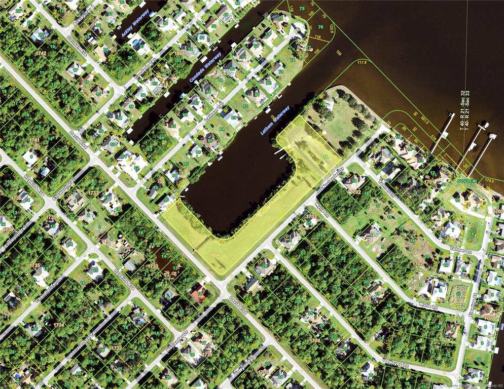 This is an aerial map showing residential lots, waterways, and streets in a suburban neighborhood — 3119 GILLOT BOULEVARD, PORT CHARLOTTE, FL