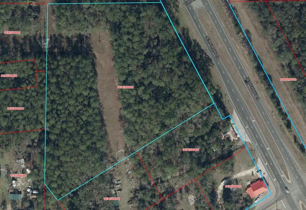 An aerial map shows a wooded parcel of land outlined in blue next to a highway — 00 SE US 19 HIGHWAY, OTTER CREEK, FL