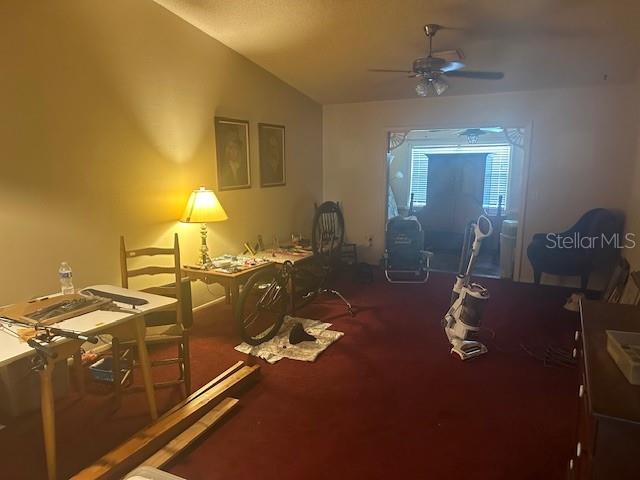 A room with red carpeting, a ceiling fan, a desk, and a bicycle — 5445 18TH COURT W, BRADENTON, FL
