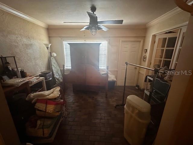 A room with a brick floor, ceiling fan, and a large wooden bed frame — 5445 18TH COURT W, BRADENTON, FL