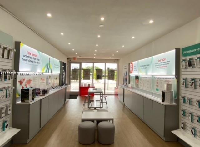 A bright retail store interior features display walls, product shelving, and a central seating area — 789 NW 37 Ave, Miami FL 33125, MIAMI, FL
