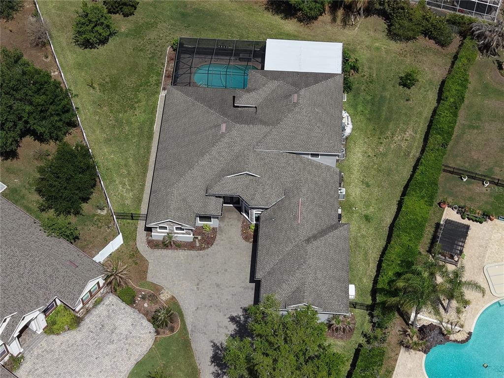 A single-story house with a stone facade, gray stucco, and a paved driveway — 2120 SOUTHERN OAKS LANE, LAKELAND, FL