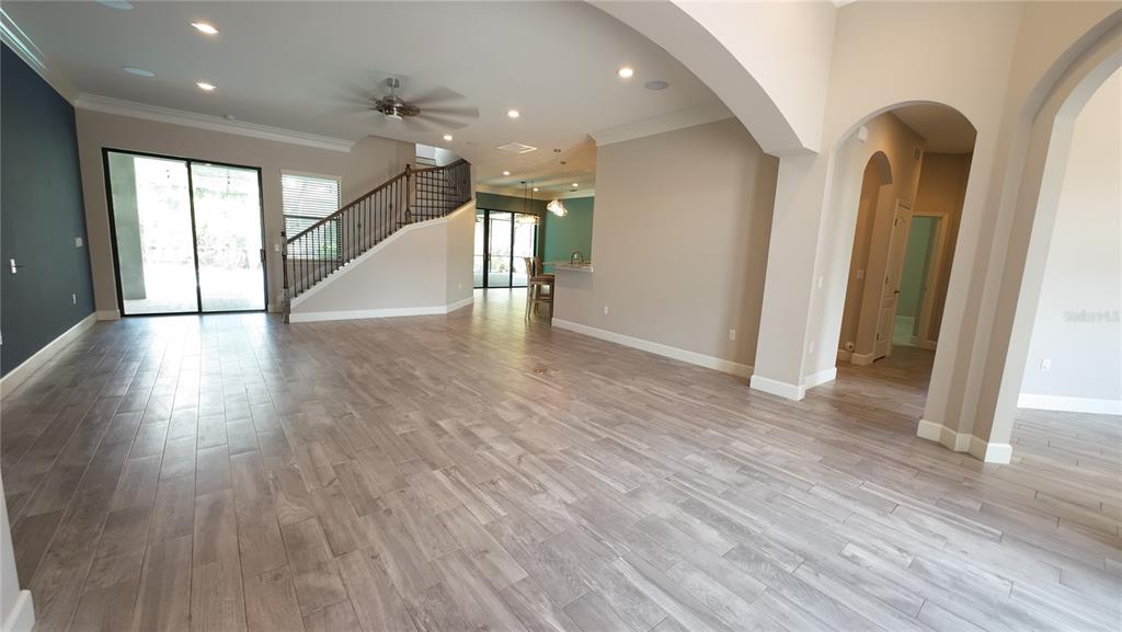 A paved walkway leads to a double front door with stone siding and arched windows — 2120 SOUTHERN OAKS LANE, LAKELAND, FL