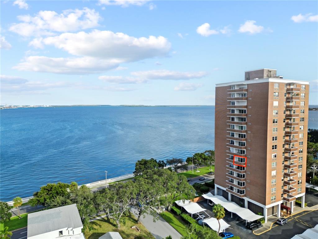 An exterior view of a high-rise apartment building overlooking a large body of water — 4015 BAYSHORE BOULEVARD UNIT 7C, TAMPA, FL