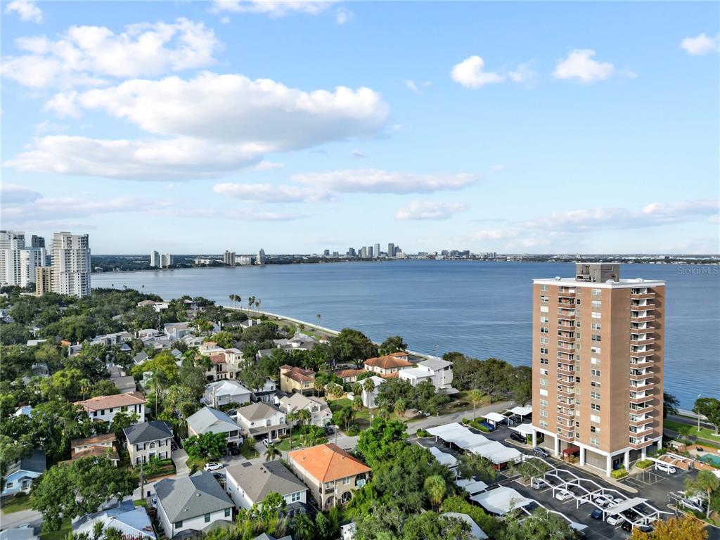 An aerial view shows a residential neighborhood, a tall apartment building, and a large bay — 4015 BAYSHORE BOULEVARD UNIT 7C, TAMPA, FL