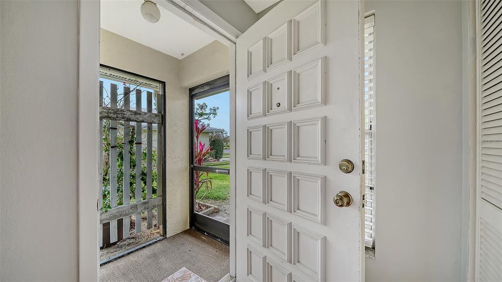 A single-story house with a light-colored exterior and a lawn under a vibrant sunset sky — 4103 CENTER GATE BOULEVARD UNIT 2, SARASOTA, FL