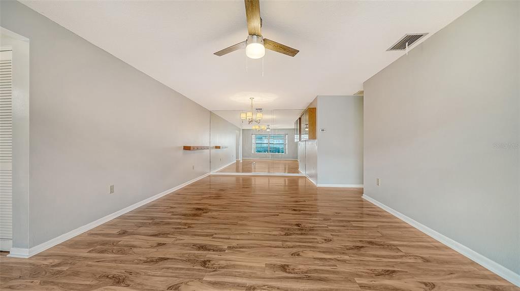 An aerial view shows a swimming pool with a covered patio area and surrounding landscaping — 4103 CENTER GATE BOULEVARD UNIT 2, SARASOTA, FL