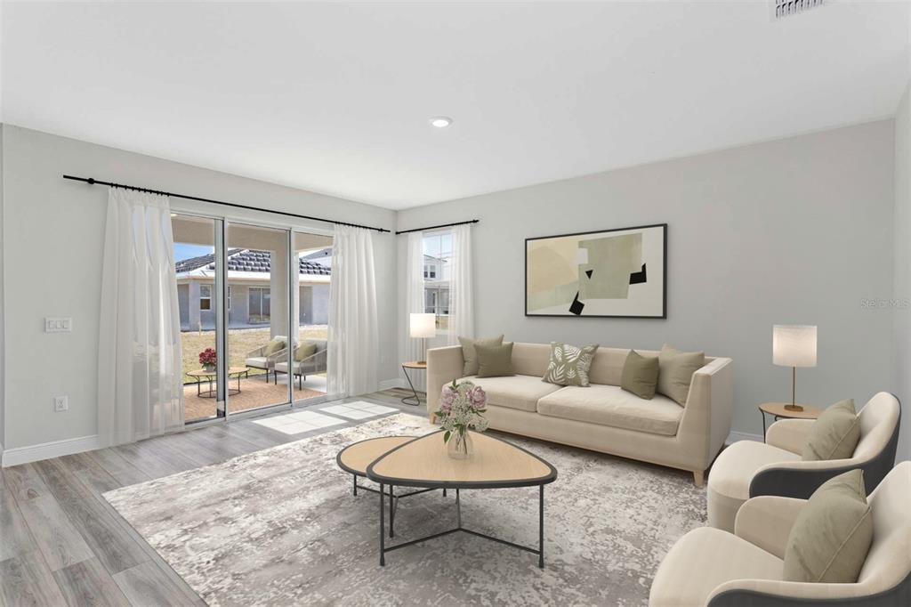 This is a digital rendering of a living room with a sofa, chairs, and patio access — 33595 TWILIGHT SEA PLACE, DADE CITY, FL