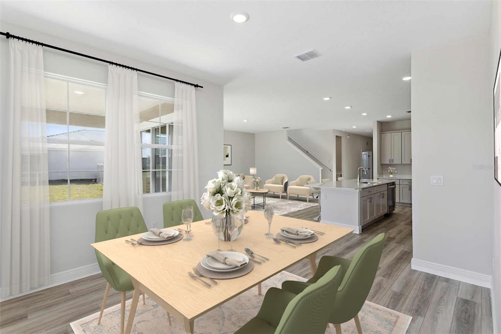 This is a digital rendering of a dining area opening into a kitchen and living space — 33595 TWILIGHT SEA PLACE, DADE CITY, FL