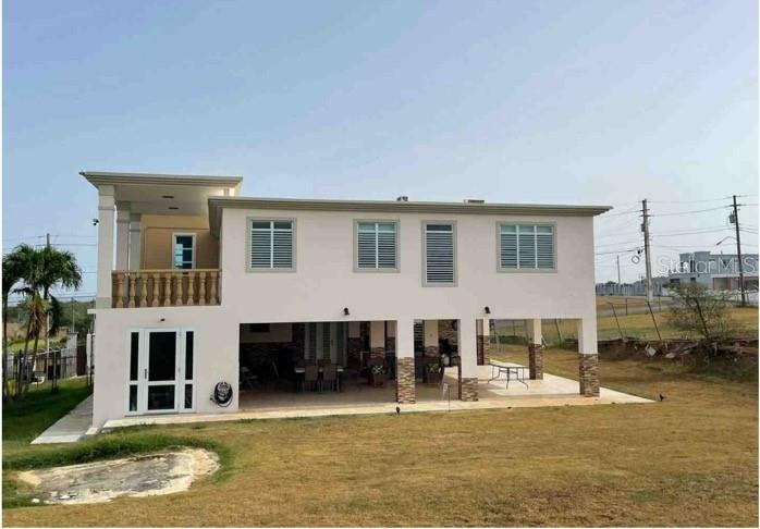 A two-story house with a covered ground-level patio and an upper-level balcony with stone railings — SR 308 km 5.8 INT SOLAR MIRADERO LOT # 2, CABO ROJO, PR