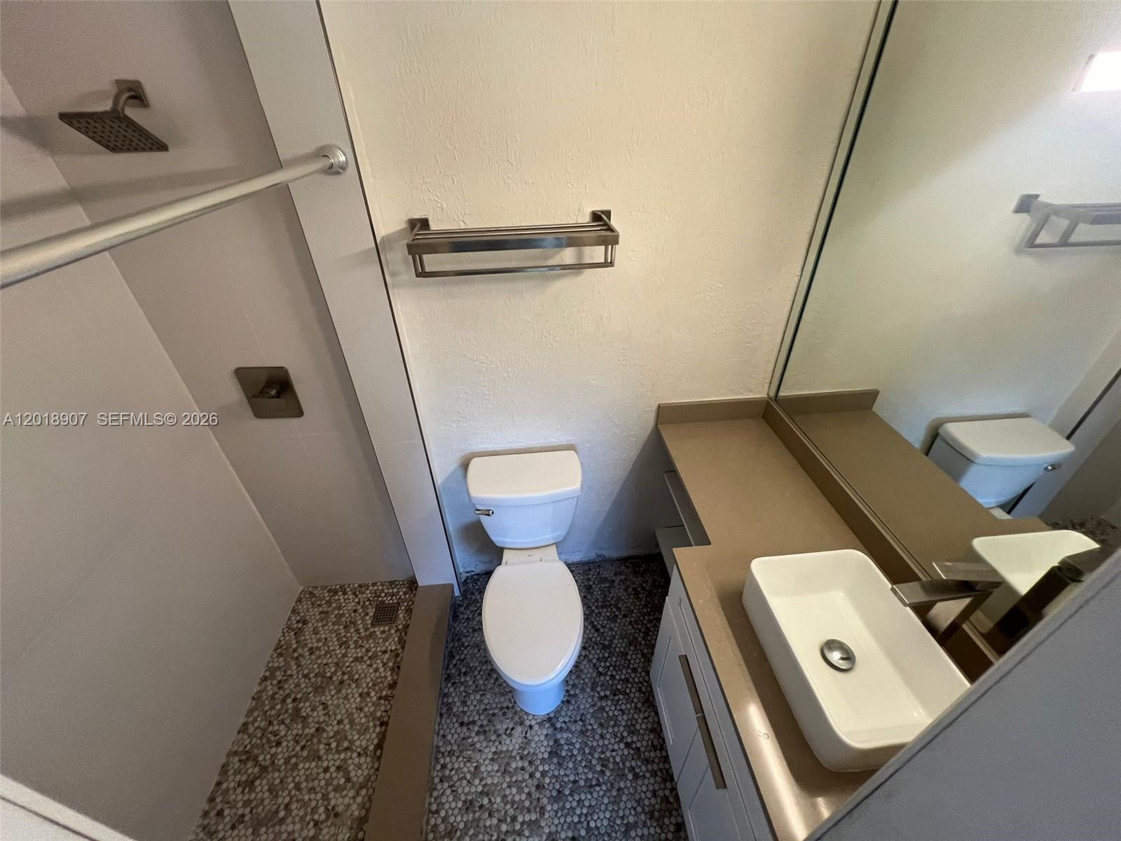A bathroom features a walk-in shower, a toilet, and a vessel sink vanity — 8600 SW 67th Ave # 938, Pinecrest FL 33156, PINECREST, FL