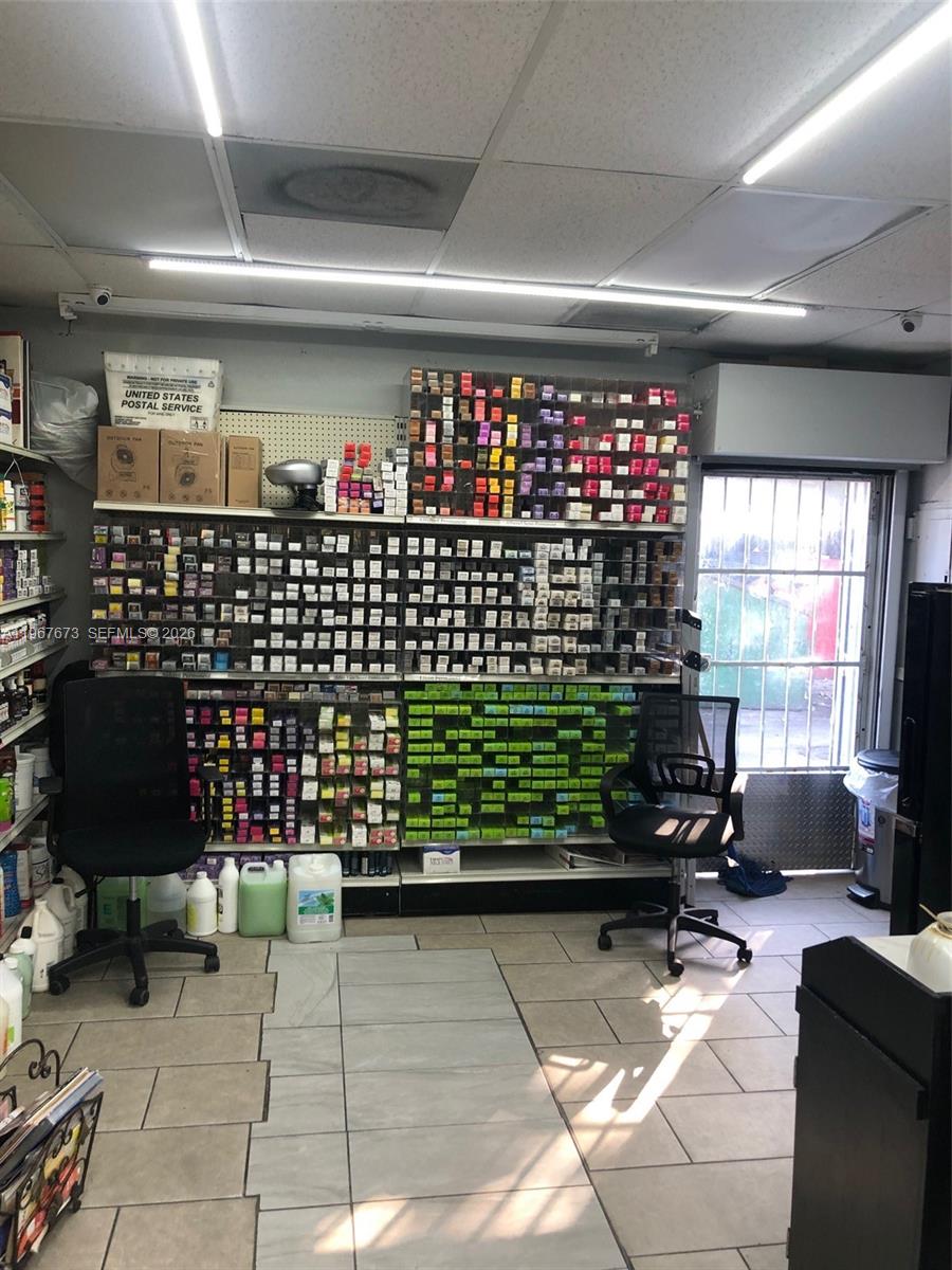 A retail space features shelves stocked with hair color products and two office chairs — 57th, Miami Gardens FL 33055, MIAMI GARDENS, FL