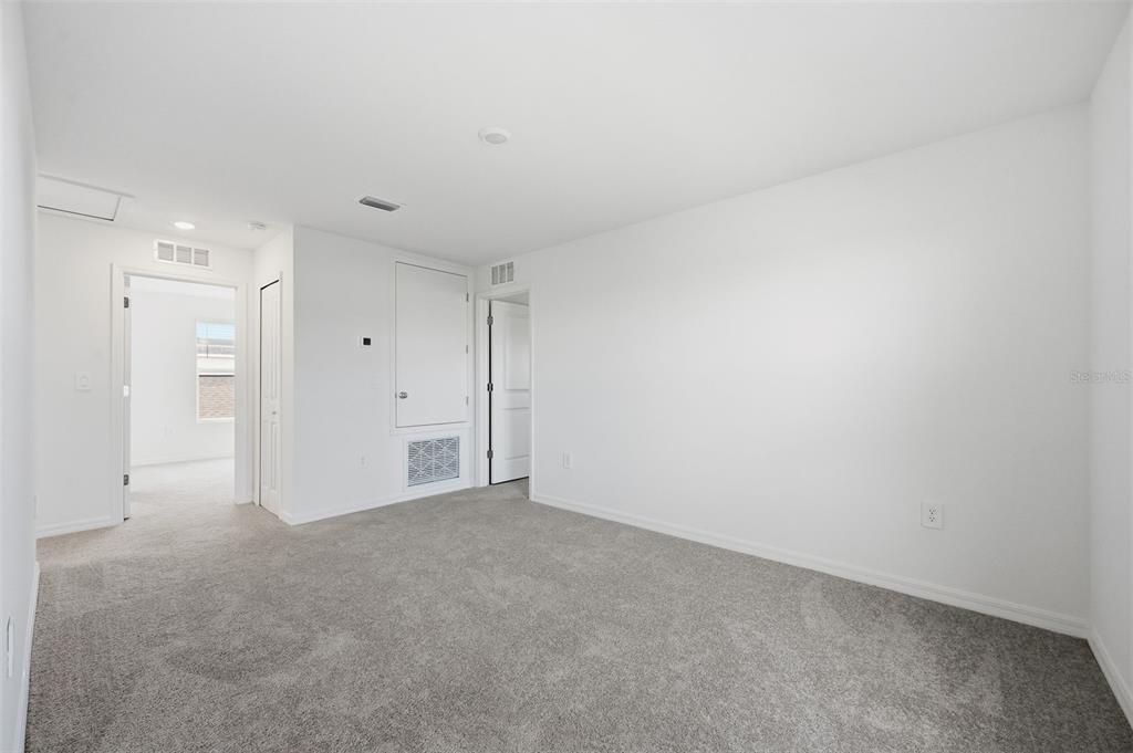 An open-concept kitchen and living area features white cabinetry, stainless steel appliances, and tile flooring — 13413 TURNLEAF BOULEVARD, PUNTA GORDA, FL