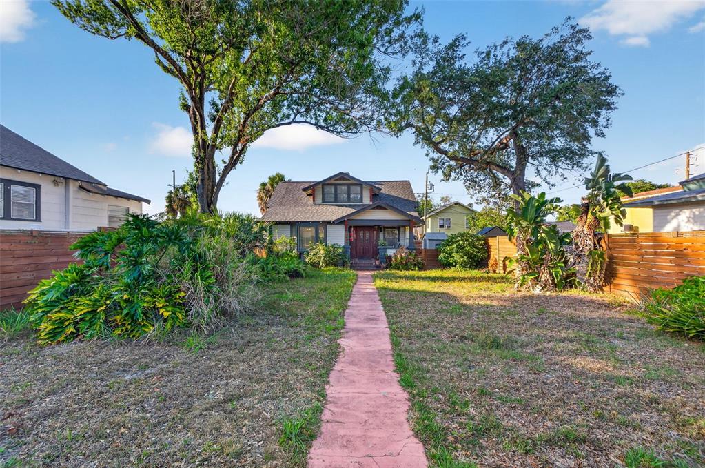 A front view of a single-story house with a walkway leading to the entrance — 2419 DARTMOUTH AVENUE N, ST PETERSBURG, FL