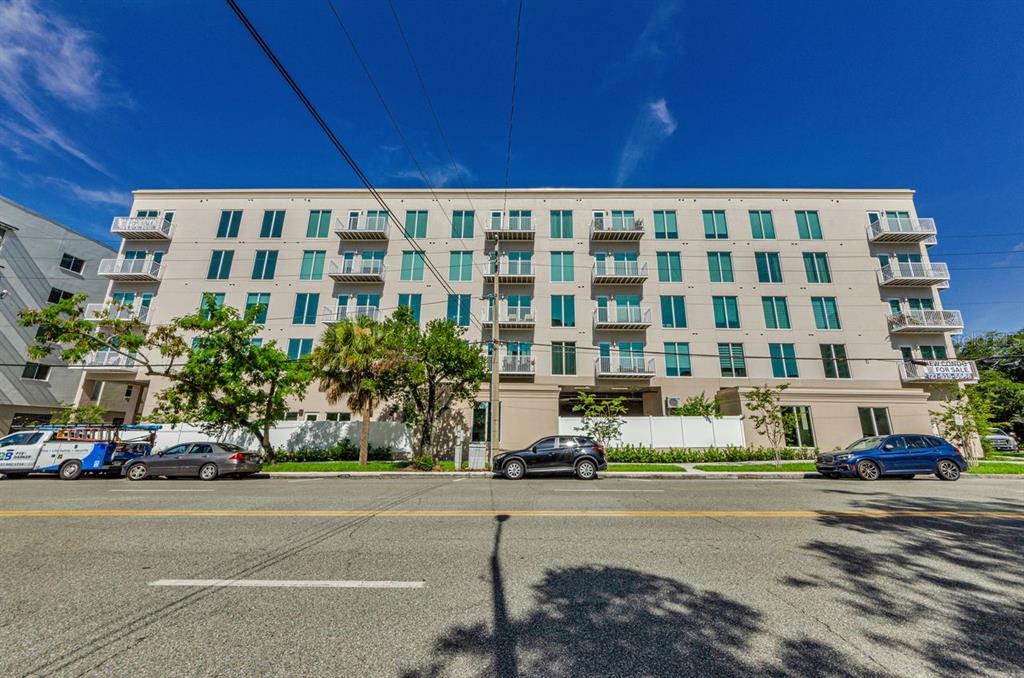 A multi-story apartment building with balconies and a parking area at street level — 600 3RD AVENUE S UNIT 301, ST PETERSBURG, FL