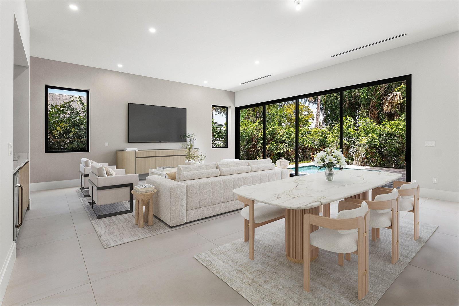 A modern open-concept living and dining area features a pool view through large sliding doors — 207 SE 5th Street, Delray Beach FL 33483, DELRAY BEACH, FL