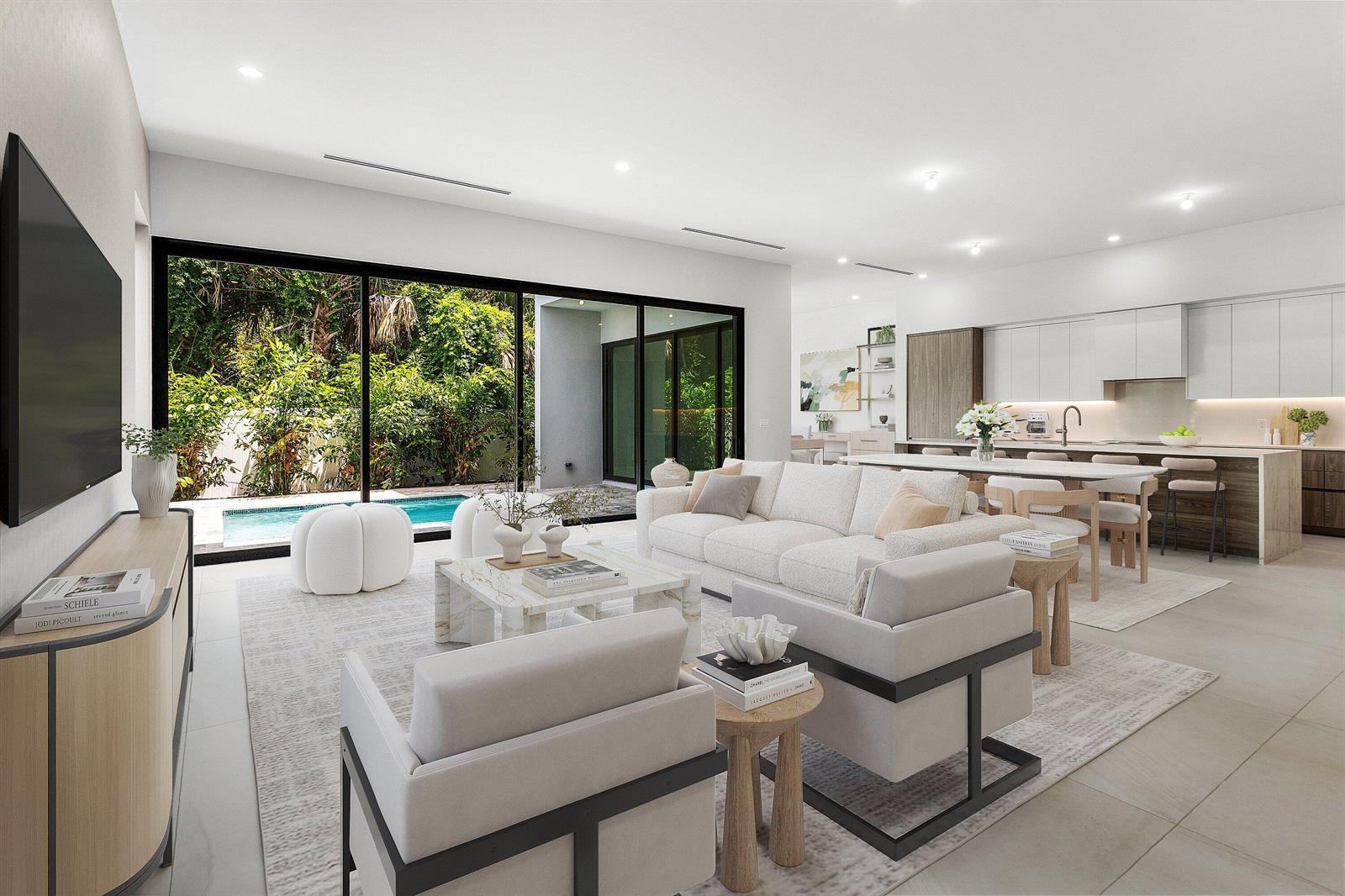 A modern open-concept living room and kitchen featuring large sliding glass doors overlooking a pool — 207 SE 5th Street, Delray Beach FL 33483, DELRAY BEACH, FL