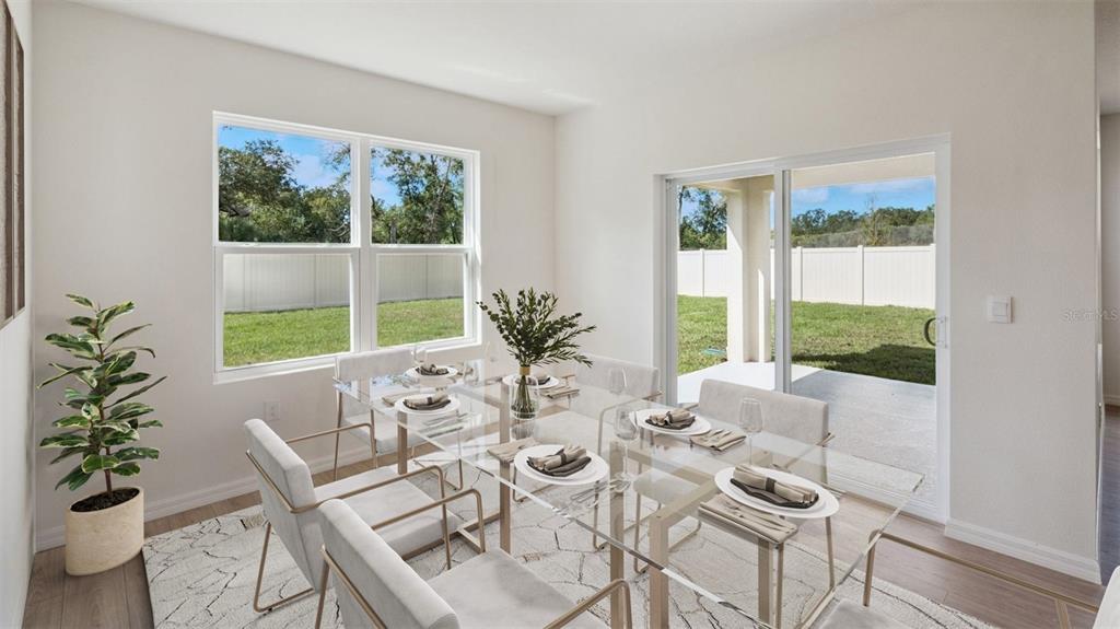 A dining room features a glass table, six chairs, a rug, and a sliding glass door — 1124 MORFONTAINE STREET, DAYTONA BEACH, FL