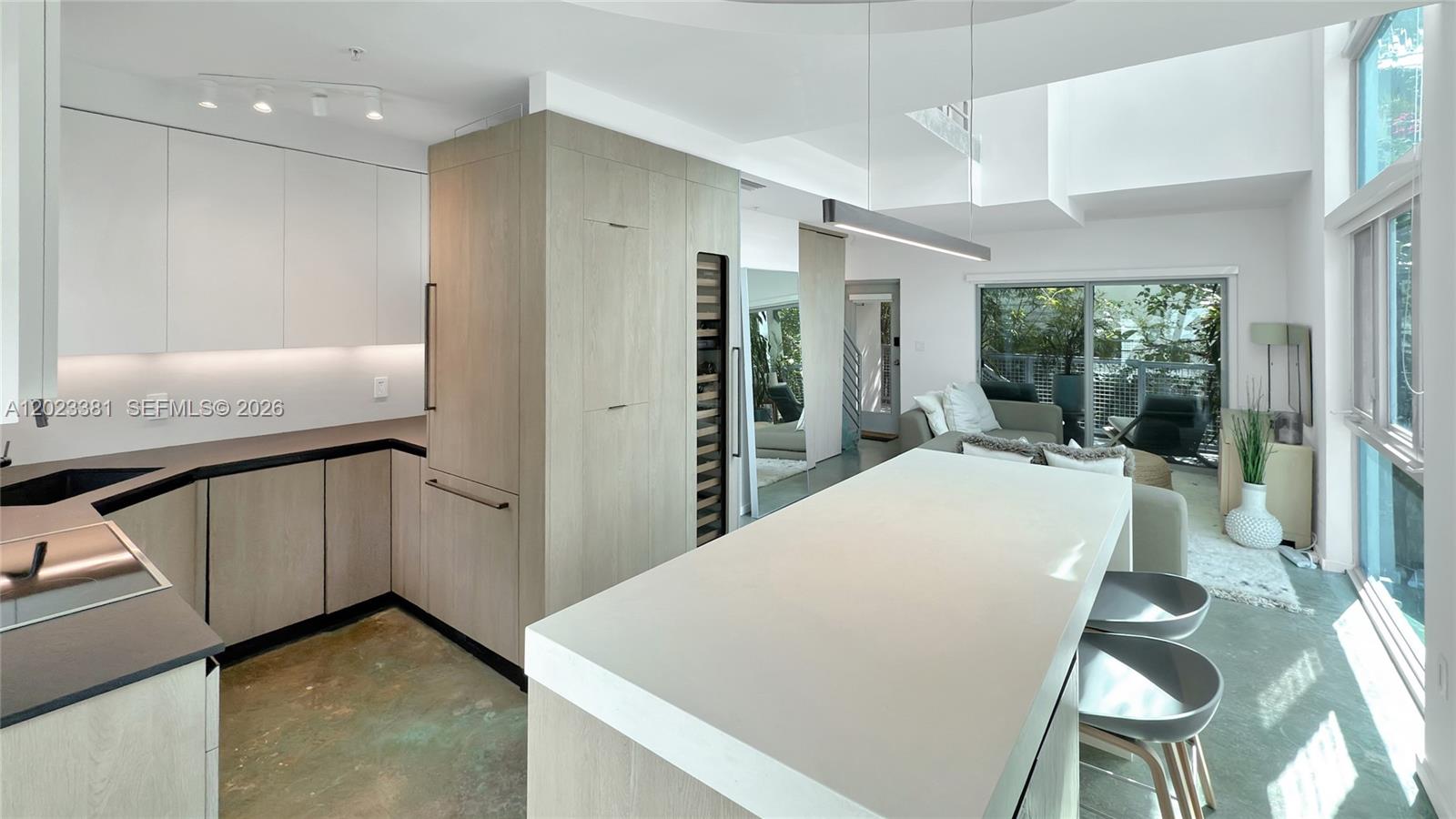 A modern multi-story building with light-colored walls is partially obscured by large, leafy trees — 734 Michigan Ave # 7, Miami Beach FL 33139, MIAMI BEACH, FL