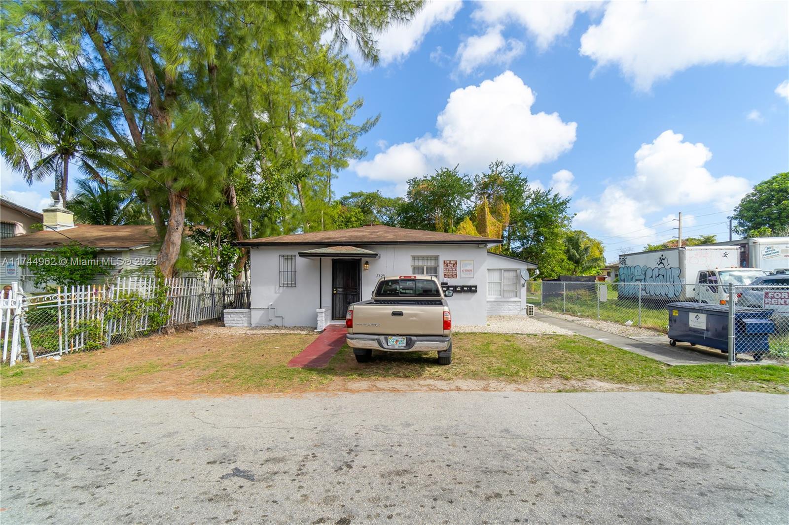 A single-story house with a beige pickup truck parked in front on a gravel lot — 7525 NE Miami Ct, Miami FL 33138, MIAMI, FL