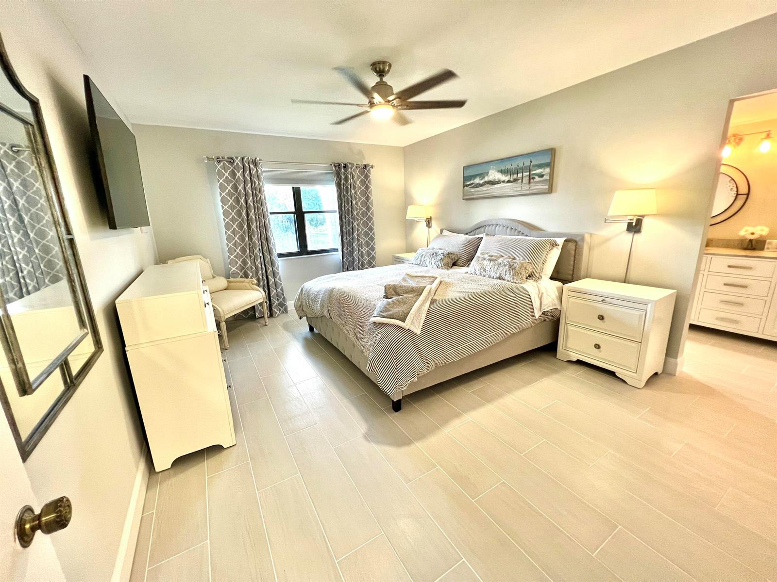 A bedroom features a bed, white furniture, tile flooring, and a ceiling fan — 17081 Waterbend Dr Drive Unit 229, Jupiter FL 33477, JUPITER, FL