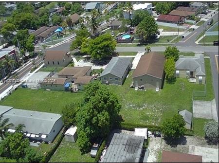 An aerial view shows several residential buildings and a large grassy lot in a neighborhood — 516 NW 4th Ave, Hallandale Beach FL 33009, HALLANDALE BEACH, FL