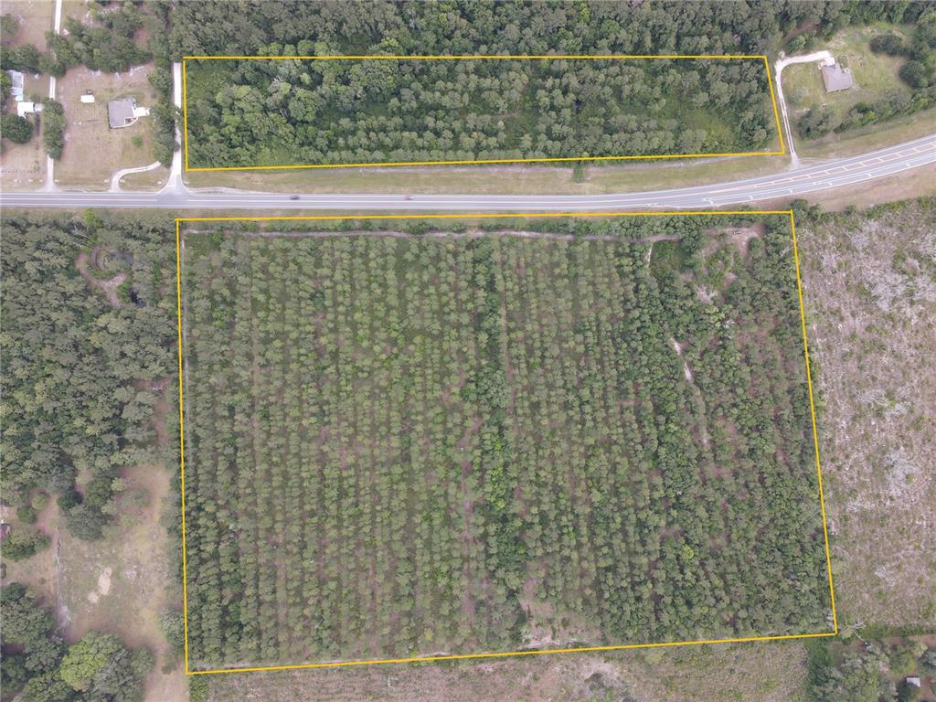 An aerial view shows two plots of land separated by a paved road — TBD N STATE ROAD 121, ALACHUA, FL
