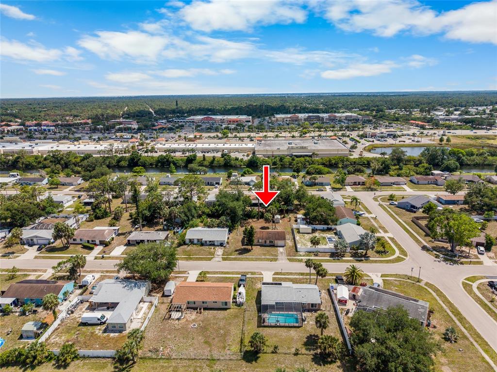 An aerial view shows a residential neighborhood with a red arrow pointing to a house — 4577 MARALDO AVENUE, NORTH PORT, FL