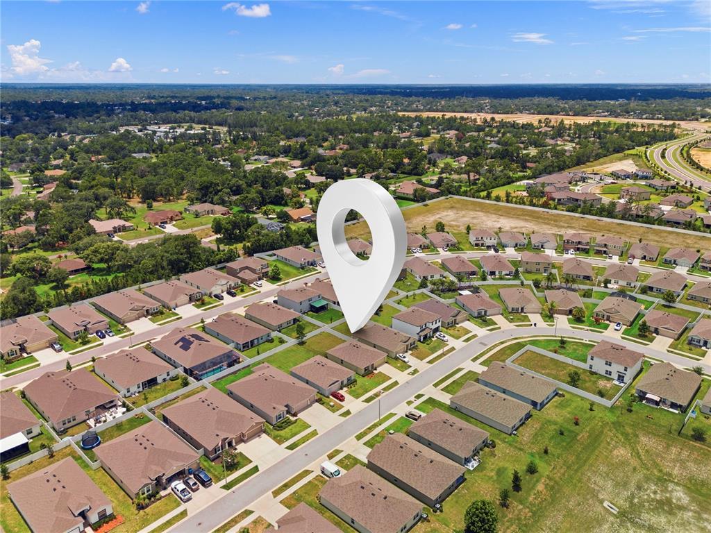 An aerial view shows a suburban neighborhood with a large location pin marking a house — 13322 GOLDEN LIME AVENUE, SPRING HILL, FL