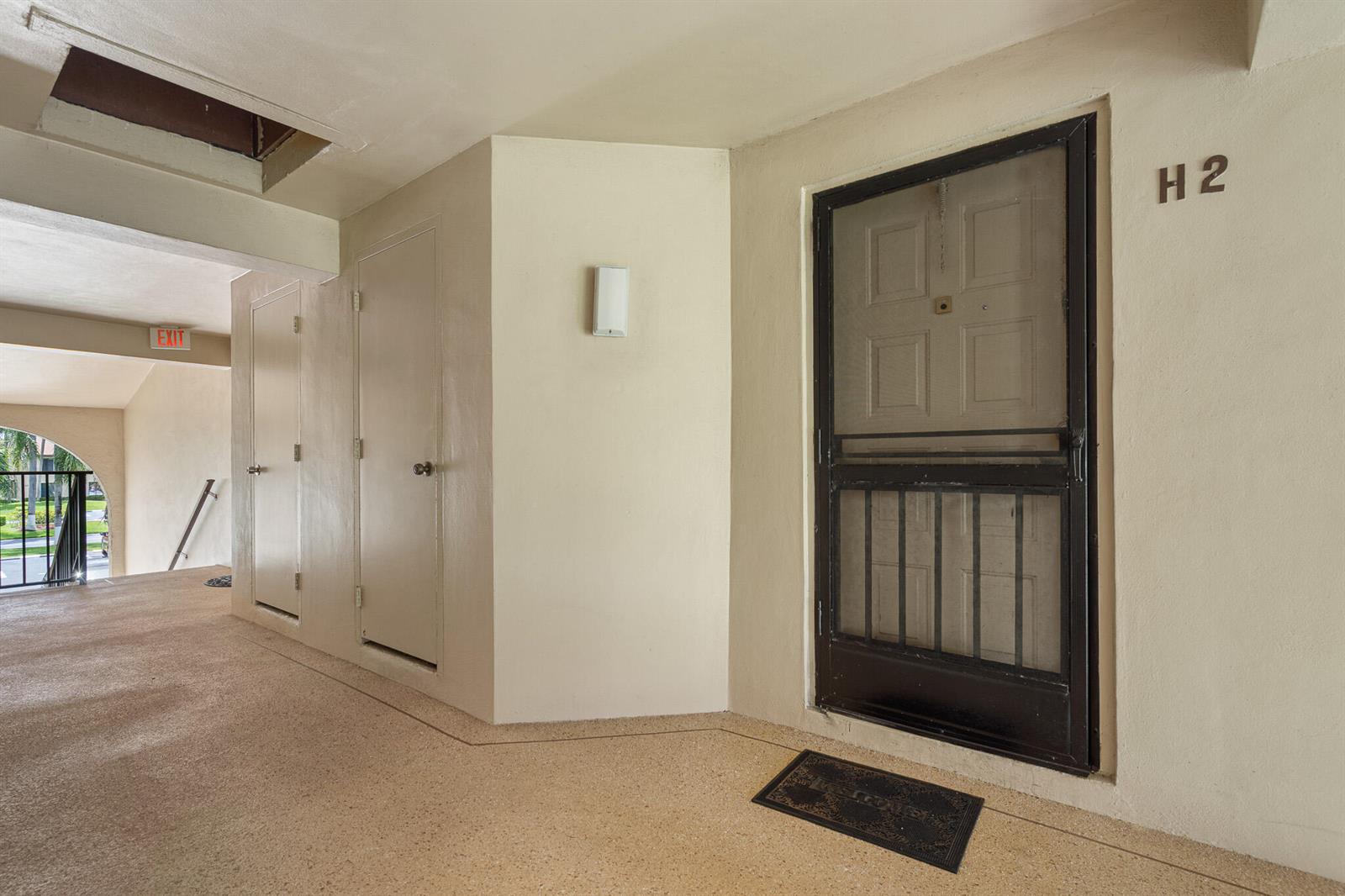 An exterior hallway shows a door labeled H2, a screen door, and two utility closets — 610 Sea Pine Way # H2, FL 33415, FL