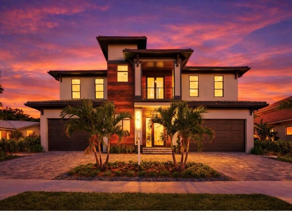 A two-story modern house with a wood-paneled center, two garages, and palm trees at sunset — 736 Lagoon Drive, North Palm Beach FL 33408, NORTH PALM BEACH, FL