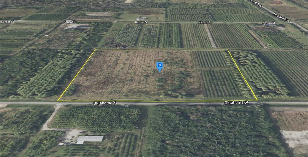 An aerial view shows a rectangular, undeveloped plot of land bordered by two streets — 1608 OKLAHOMA STREET, OVIEDO, FL