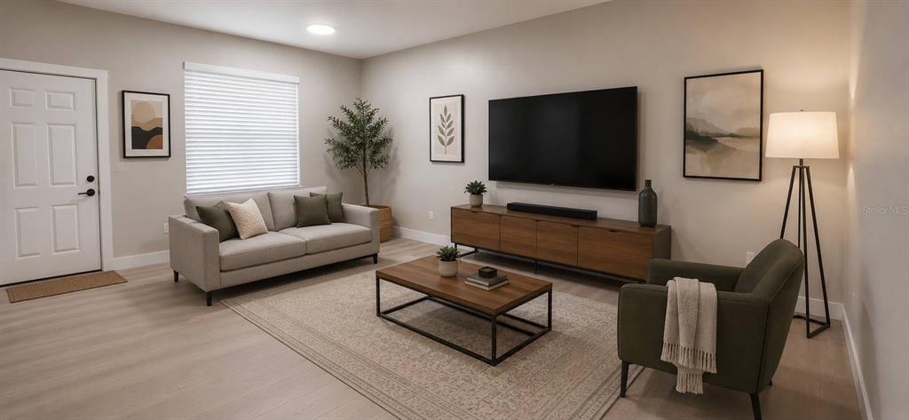 A modern living room features a gray sofa, a wood media console, and a floor lamp — 1244 23RD STREET, ORLANDO, FL