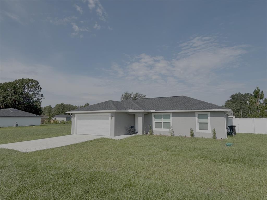 A single-story gray house with a two-car garage and a concrete driveway — 3722 SW 149TH TERRACE, OCALA, FL