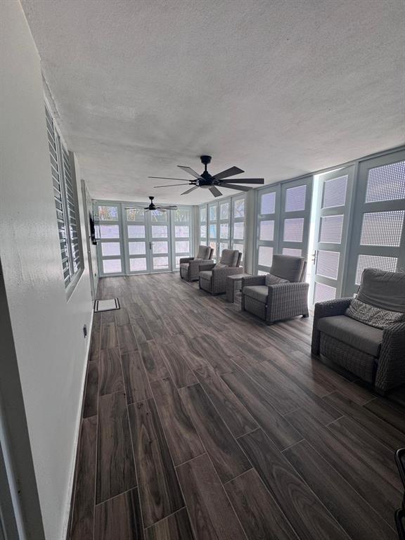 A sunroom features wood-look tile flooring, two ceiling fans, and multiple glass-paneled doors — 59 REXVILLE DEVELOPMENT UNIT BM-26, BAYAMON, PR