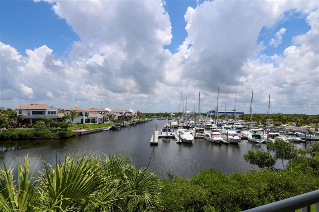 A view of a marina with numerous docked sailboats and yachts beside waterfront residential homes — 447 BAHIA BEACH BOULEVARD, RUSKIN, FL