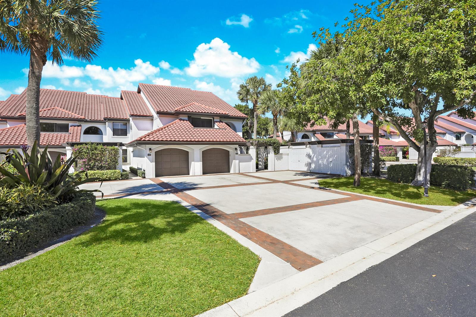 A kitchen features white cabinets, stainless steel appliances, open wood shelving, and blue accent walls — 16671 Traders Crossing Crossing N # 121, Jupiter FL 33477, JUPITER, FL