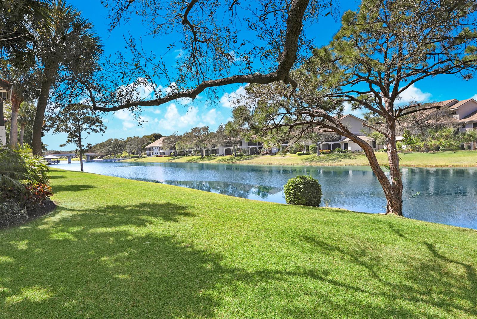 A two-story townhouse with a tiled roof, two-car garage, and a paved driveway — 16671 Traders Crossing Crossing N # 121, Jupiter FL 33477, JUPITER, FL