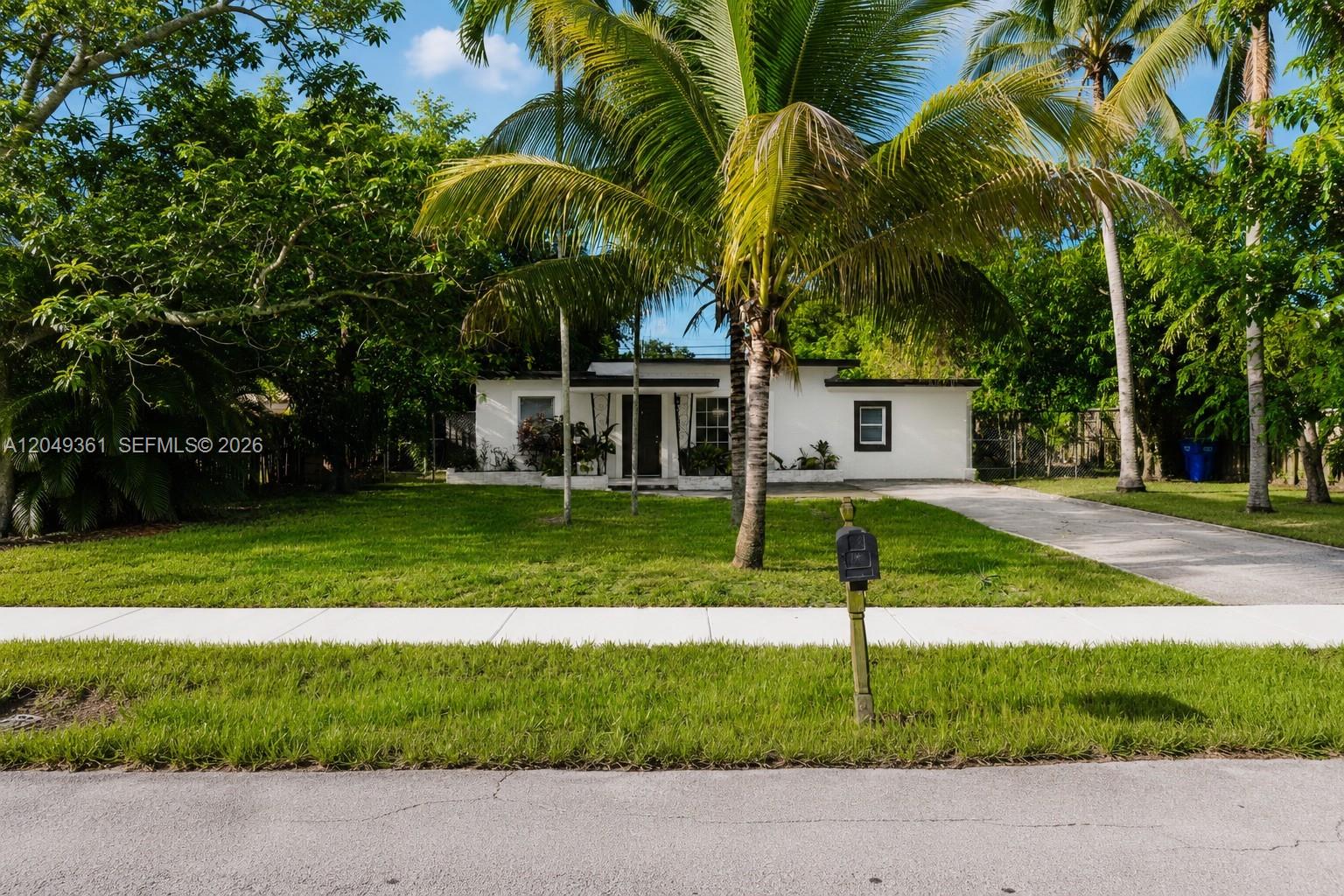 A single-story white house with a palm tree in the front yard — 6130 Flagler St, Hollywood FL 33023, HOLLYWOOD, FL