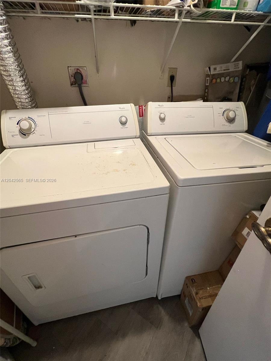 A laundry room features a white top-loading washing machine and a matching clothes dryer — 9429 Fontainebleau Blvd # 33, Miami FL 33172, MIAMI, FL