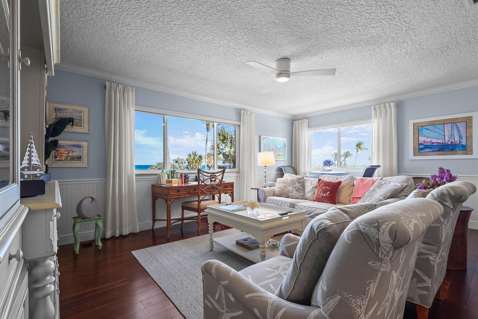 A living room with light blue walls, hardwood floors, a desk, and ocean views — 250 S Ocean Boulevard # 254, Delray Beach FL 33483, DELRAY BEACH, FL