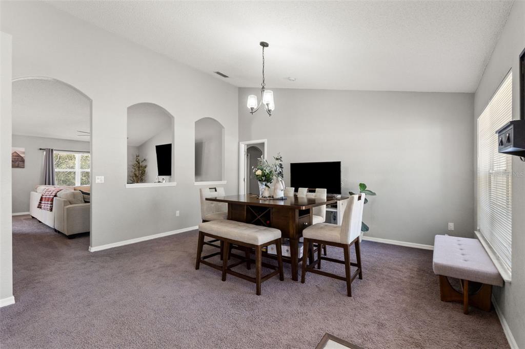 A kitchen with wooden cabinets, a central island, and stainless steel appliances on tiled floors — 15335 FLEETWOOD ROAD, WEEKI WACHEE, FL