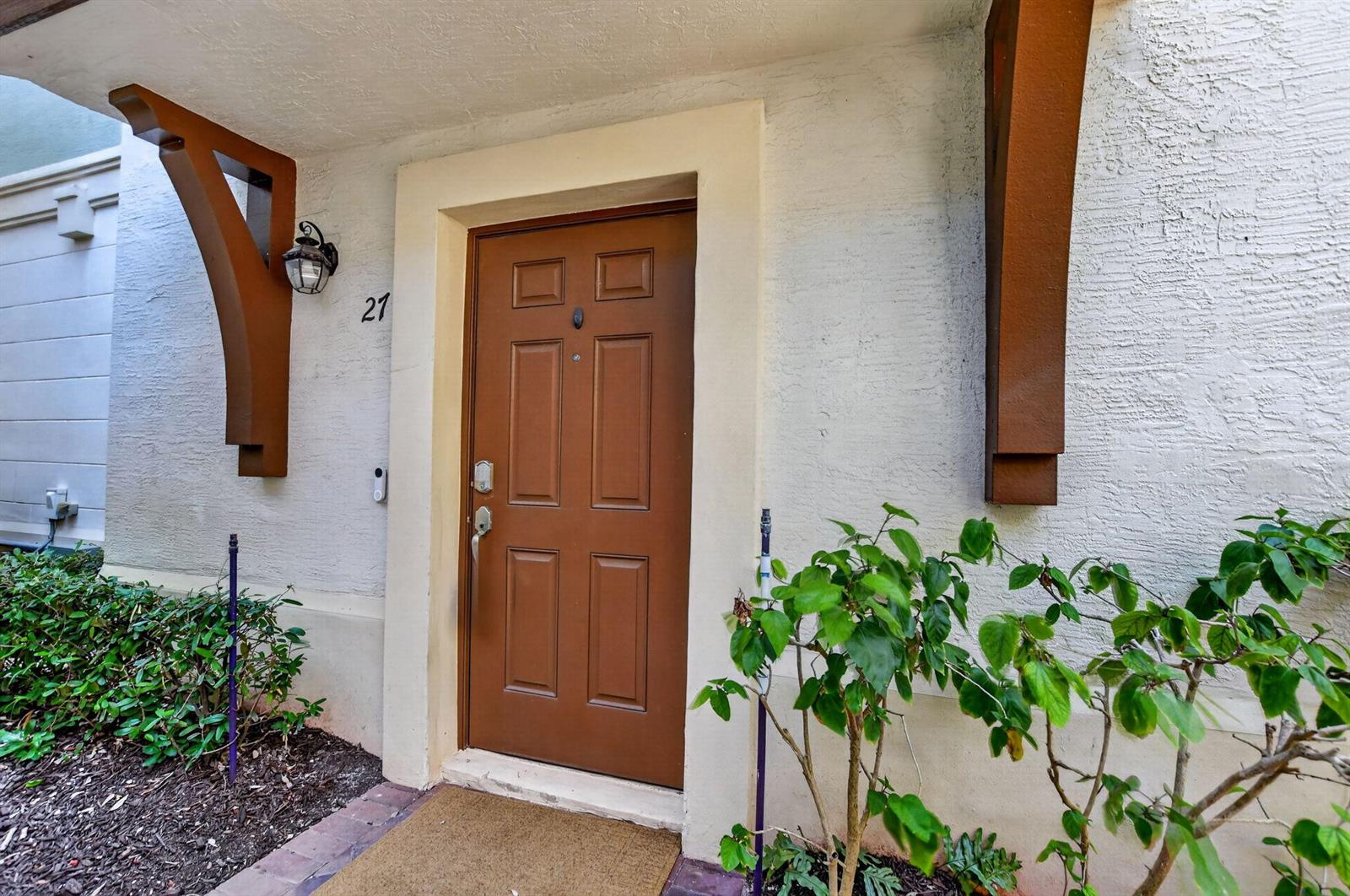 A brown front door with a number 21 sign is set in a stucco exterior — 27 NW Hawthorne Place, Boca Raton FL 33432, BOCA RATON, FL